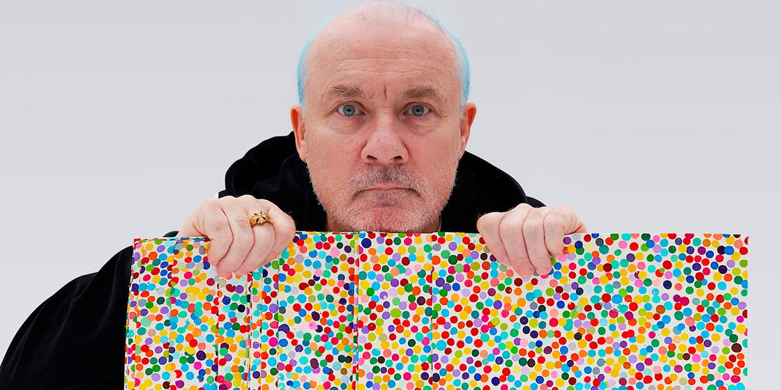 Damien Hirst with artworks from The Currency series